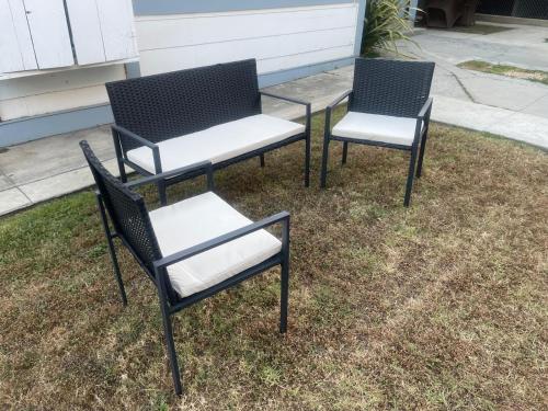 two black and white chairs sitting on the grass at Females room bunk beds in Los Angeles