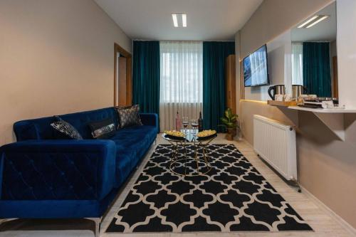 a living room with a blue couch and a table at Lina Suit Hotel in Istanbul