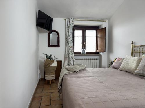 a bedroom with a large bed and a window at La Dolce Casa Centre Free Parking Family in Celano
