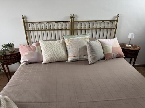 a large bed with many pillows on it at La Dolce Casa Centre Free Parking Family in Celano