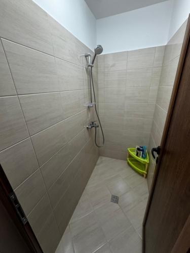 a shower in a bathroom with a tile floor at 'Oasis' Ravda Apartment, Nessebar in Ravda