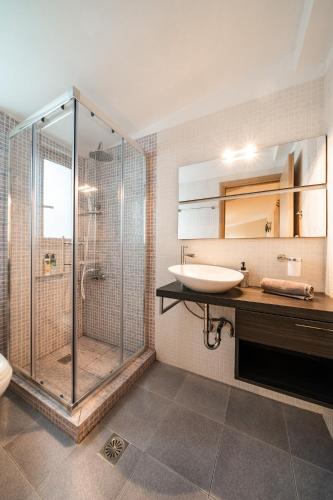 a bathroom with a shower and a sink and a toilet at White Villas Lefkada in Kalamitsi