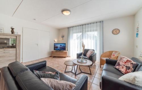 a living room with two couches and a table at Oesterbaai 8 Personen in Wemeldinge