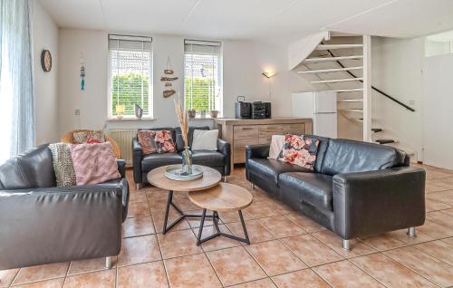 a living room with two leather couches and a table at Oesterbaai 8 Personen in Wemeldinge