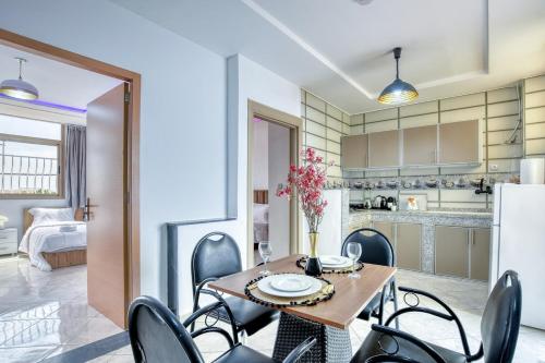 a kitchen and dining room with a table and chairs at White Majorelle Duna Blanca in Tamraght Ouzdar