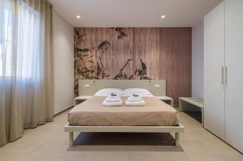 a bedroom with a bed with two towels on it at Dolce Marea Bed&Spa in Gaeta
