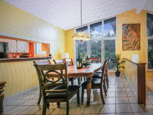 a dining room with a wooden table and chairs at Canterbury Oasis in Haines City