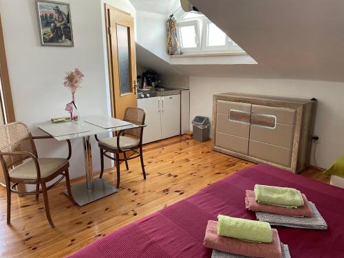 a living room with a table and a kitchen at Apartments Villa More in Makarska