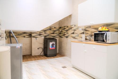 a kitchen with a trash can in the corner at Ground Floor Gem - Patio Lounge in Cairo