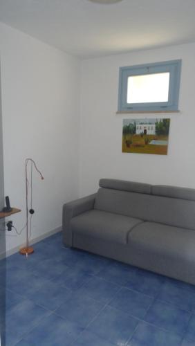 a living room with a couch and a window at Borgo Rosso di Sera - Resort Country Chic in San Lucido