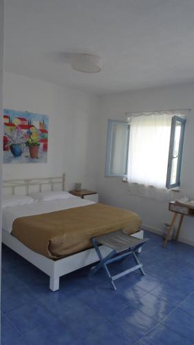 a bedroom with a bed and a window at Borgo Rosso di Sera - Resort Country Chic in San Lucido