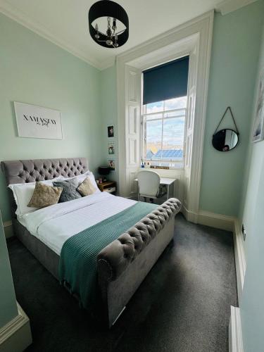 a bedroom with a large bed and a window at Bernard Street Edinburgh Apartment in Edinburgh