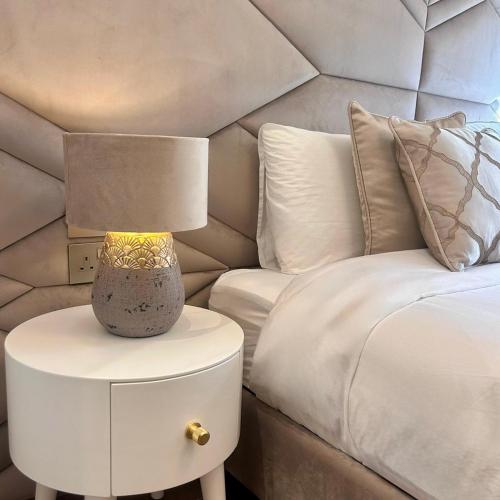 a lamp on a night stand next to a bed at Palazzo De La Sengle Boutique Hotel in Senglea