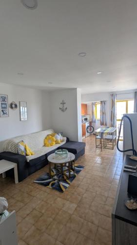a living room with a bed and a table at Praia da Rocha Apartamento Costa Azul in Portimão