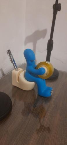 a toy toilet with a toothbrush on a table at Apê confortável, com Alexa. Ótima localização in Ilhéus