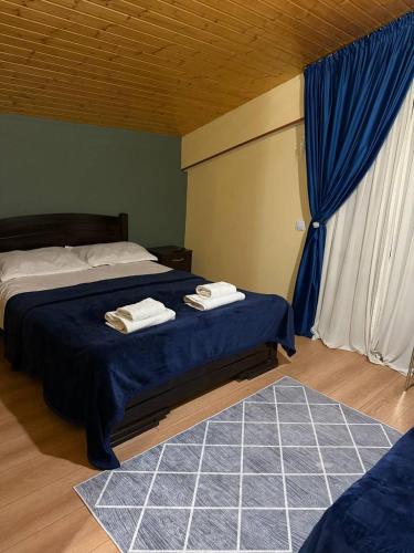 a bedroom with a bed with two towels on it at Sunny Hill Gudauri in Gudauri
