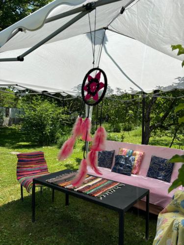 a white tent with a pink couch and a table at Cozy Family Home 