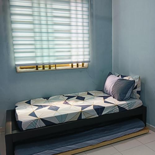 a bed in a room with a window at Dang anum homestay in Segamat