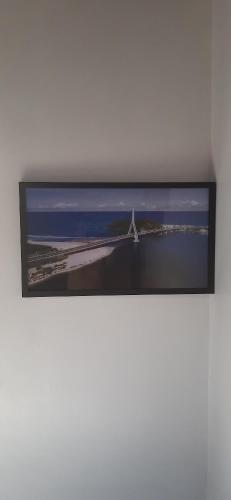 a picture of a bridge on a wall at Apê confortável, com Alexa. Ótima localização in Ilhéus