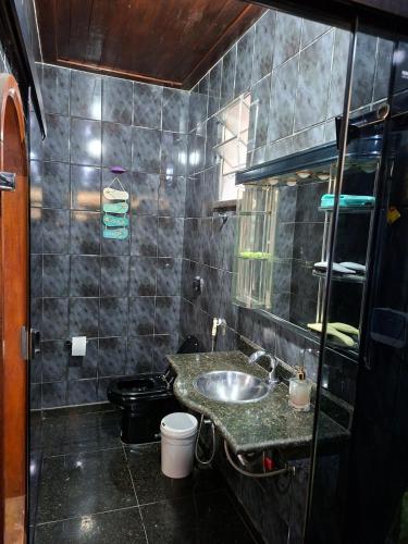 a bathroom with a sink and a toilet at Apê confortável, com Alexa. Ótima localização in Ilhéus