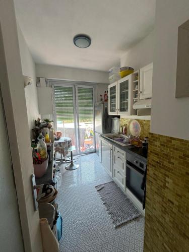 une cuisine avec un évier et une cuisinière four supérieur dans l'établissement Appartement Nice promenade des anglais, à Nice
