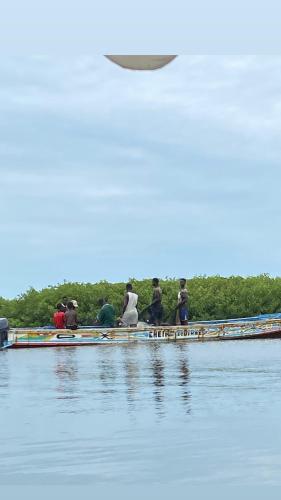 a group of people on boats on the water at Jamebougoum in Mar Lodj