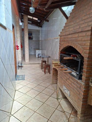 a brick oven in a room with a table at Apê confortável, com Alexa. Ótima localização in Ilhéus