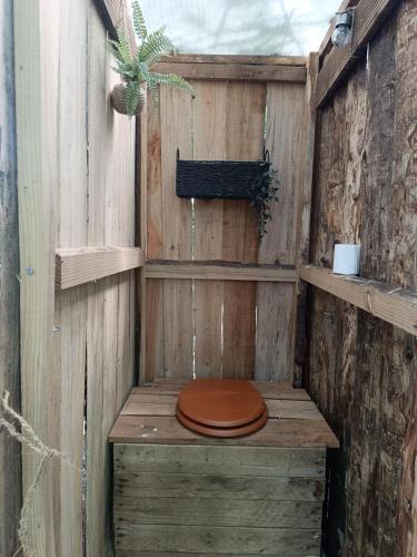 a wooden toilet with a brown toilet seat in a sauna at cabane ô domaine södjé in Saint-Yrieix-sous-Aixe