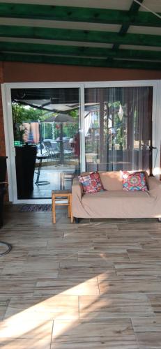 a living room with a couch and a table at Smestaj sa bazenom Sunny Hill in Smederevska Palanka