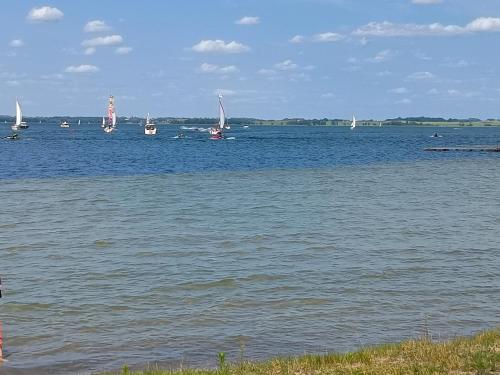 a large body of water with boats in the water at Dom Mazurska Apartamenty in Rydzewo