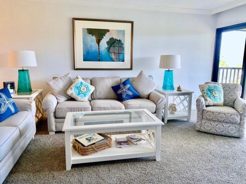 a living room with a couch and a table at Sanibel Sunset Where the Sun Meets the Sea in Sanibel