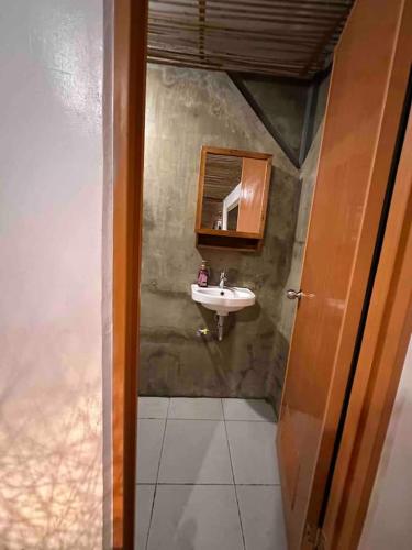 a bathroom with a sink and a mirror at Rest house cozy in San Fabian