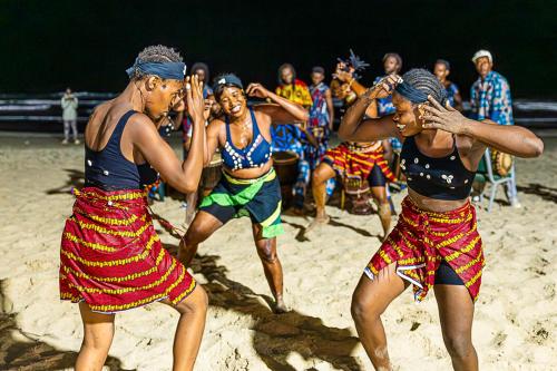 a group of people dancing on the beach at Kombo Beach Resort in Serekunda