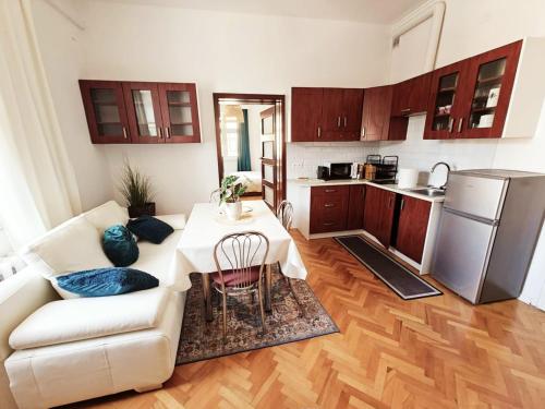 a living room with a couch and a table and a kitchen at Old Town View in Rzeszów