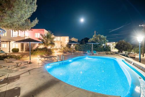 a large blue swimming pool at night at CrossRhodes Villas in Pefki Rhodes