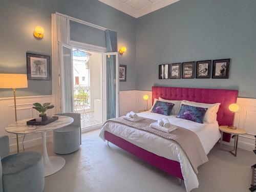 a bedroom with a large bed with a red headboard at Luxury Suite - Free WifI - Smart Tv - centro Storico in Mesagne