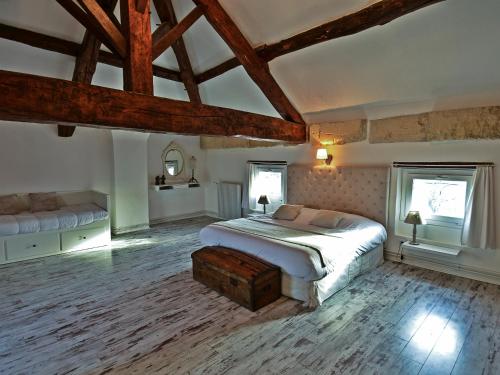 a bedroom with a large bed and two windows at Le Petit Domaine de Colayrac in Colayrac-Saint-Cirq