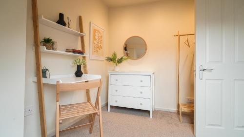 a room with a desk and a chair and a dresser at Crookes Gem with Garden & Alpacas Nearby in Walkley