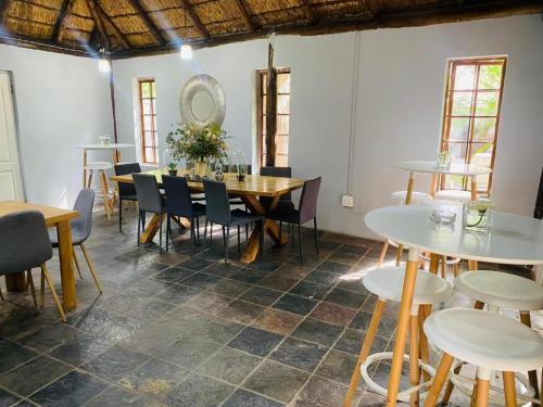 a dining room with a table and chairs at Boutique at milner guesthouse in Bloemfontein