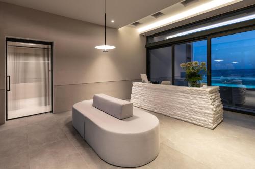 a modern office with a white chair and a desk at Orion Tinos Suites in Vrachonisída Chántra