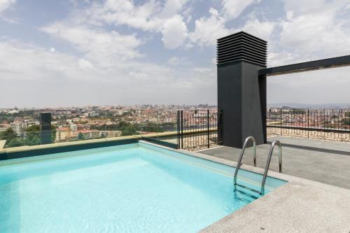 a swimming pool on the roof of a building at Douro Tower Loft - Shared Pool in Vila Nova de Gaia