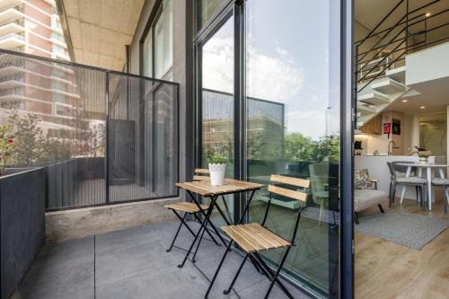 a balcony with a table and chairs in a building at Douro Tower Loft - Shared Pool in Vila Nova de Gaia