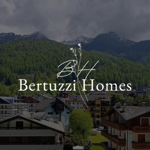 a sign that says benjamin homes in front of a mountain at BERTUZZI HOMES "Luxury Chalet" in Aprica