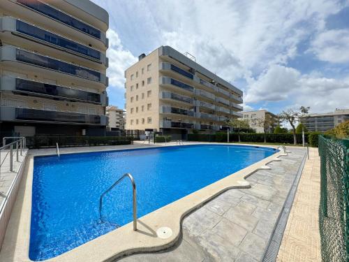 a large swimming pool in front of a building at NOVA PINEDA 2 y VISTAS PISCINA in La Pineda