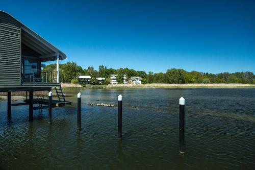 a dock in the water with a house in it at Im-Jaich Wasserferienwelt in Lauterbach