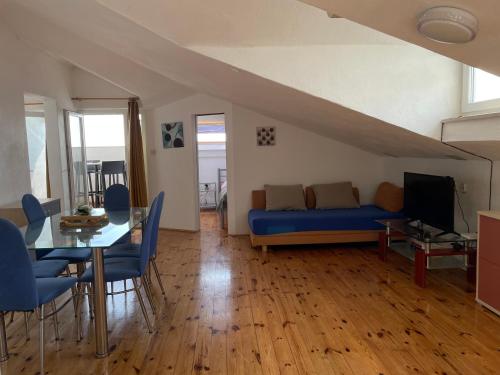 a living room with a blue couch and a table at Apartments Villa More in Makarska