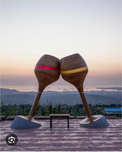two sculptures of two wine glasses sitting on a table at Apartment Moon in Pobegi