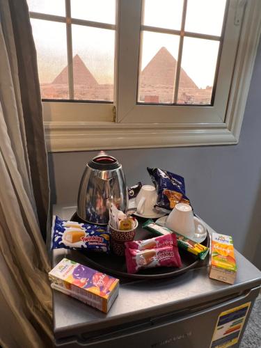 a table with food on it in a room with a window at Mena Pyramids Hotel in Cairo