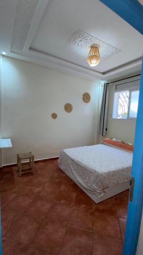 a bedroom with a bed and a window at Moroccan Family House in Agadir