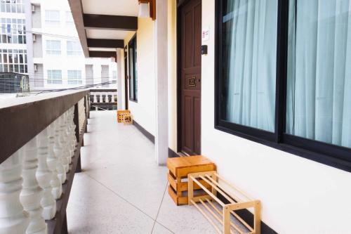 a corridor of a building with a bench and a door at October Hostel ChiangMai in Chiang Mai